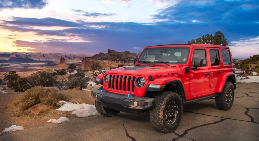 Red offroad vehicle parked beside the road